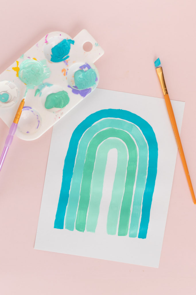 5-Minute Wall Art Idea! DIY Monochromatic Rainbow Art // Decorate with simple hand-painted monochromatic rainbows to make custom wall art in minutes! #wallart #homedecor #rainbows #papercrafts #cardstock #painting #monochromatic