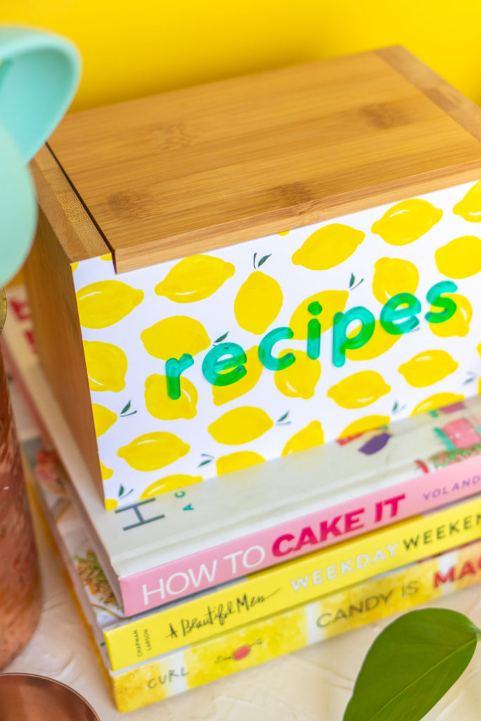 DIY Recipe Box Makeover with Wallpaper // Use removable wallpaper to makeover a simple wood recipe box! Add printable recipe cards and cute dividers to organize recipes in style! #diyideas #homedecor #recipecards #papercrafts #wallpaper #easydiy #giftideas #diygifts #diystorage #storageideas