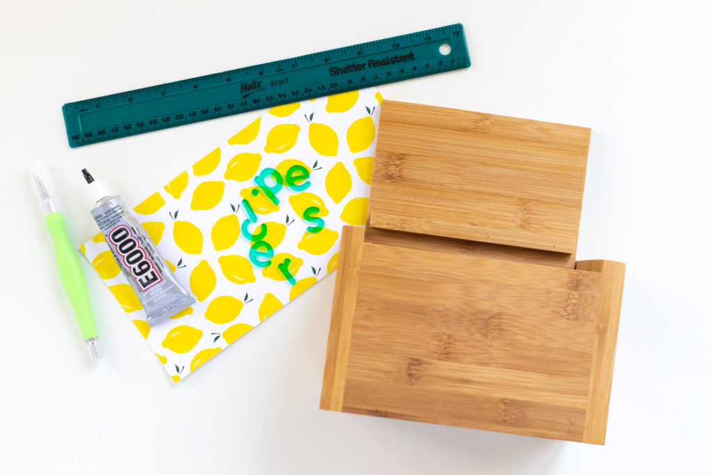 DIY Recipe Box Makeover with Wallpaper // Use removable wallpaper to makeover a simple wood recipe box! Add printable recipe cards and cute dividers to organize recipes in style! #diyideas #homedecor #recipecards #papercrafts #wallpaper #easydiy #giftideas #diygifts #diystorage #storageideas