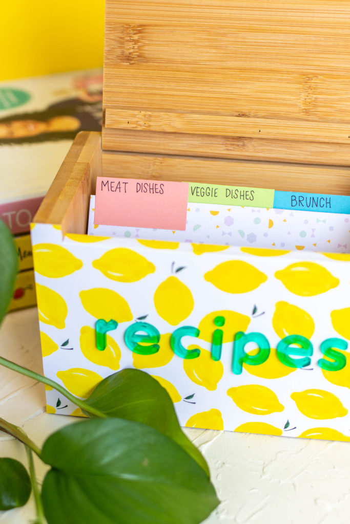 DIY Recipe Box Makeover with Wallpaper // Use removable wallpaper to makeover a simple wood recipe box! Add printable recipe cards and cute dividers to organize recipes in style! #diyideas #homedecor #recipecards #papercrafts #wallpaper #easydiy #giftideas #diygifts #diystorage #storageideas