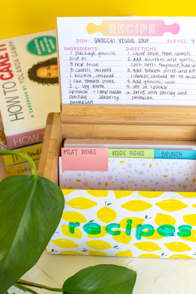 DIY Recipe Box Makeover with Wallpaper // Use removable wallpaper to makeover a simple wood recipe box! Add printable recipe cards and cute dividers to organize recipes in style! #diyideas #homedecor #recipecards #papercrafts #wallpaper #easydiy #giftideas #diygifts #diystorage #storageideas