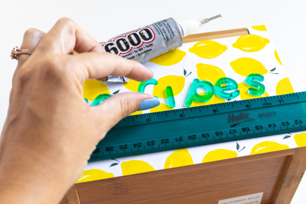 DIY Recipe Box Makeover with Wallpaper // Use removable wallpaper to makeover a simple wood recipe box! Add printable recipe cards and cute dividers to organize recipes in style! #diyideas #homedecor #recipecards #papercrafts #wallpaper #easydiy #giftideas #diygifts #diystorage #storageideas