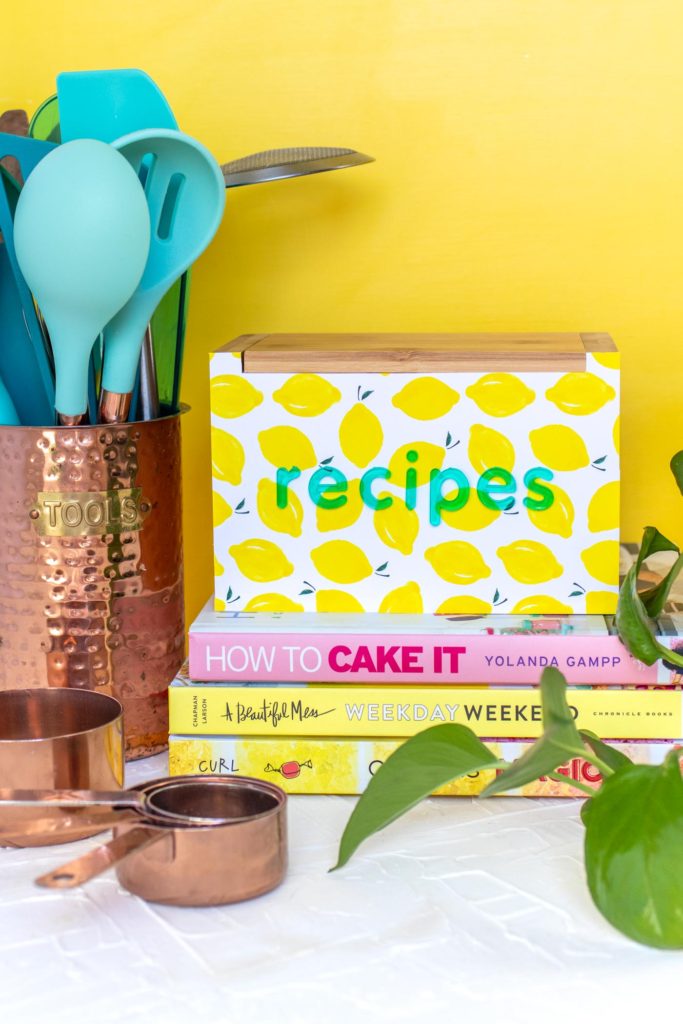 DIY Recipe Box Makeover with Wallpaper // Use removable wallpaper to makeover a simple wood recipe box! Add printable recipe cards and cute dividers to organize recipes in style! #diyideas #homedecor #recipecards #papercrafts #wallpaper #easydiy #giftideas #diygifts #diystorage #storageideas