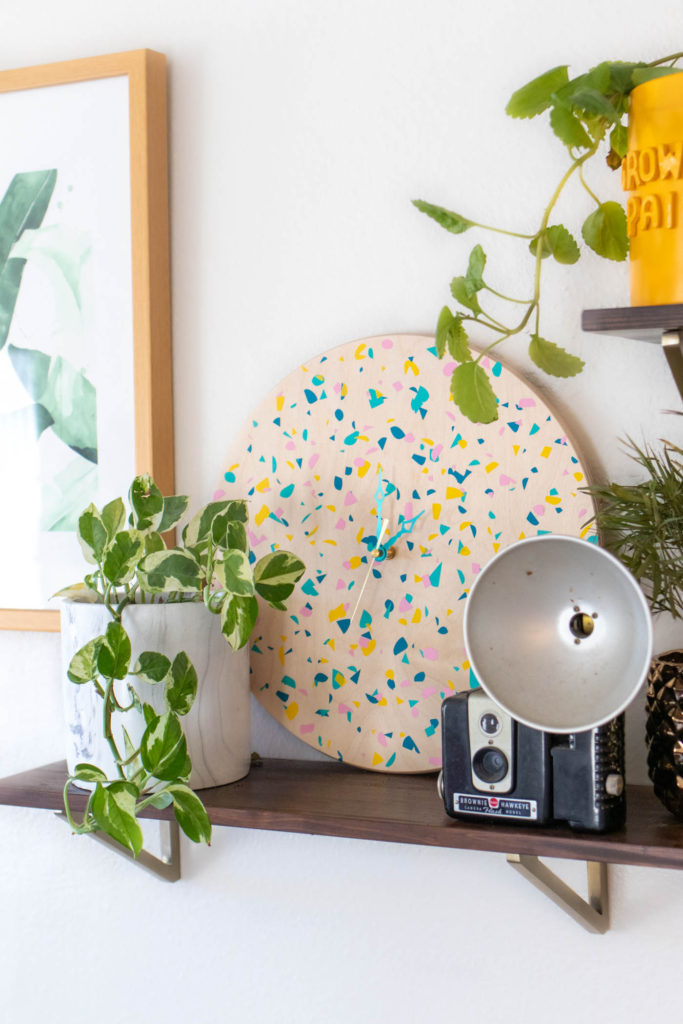 DIY Terrazzo Clock with Vinyl (Free SVG Template!) // Use your Cricut or Silhouette machine to add a colorful terrazzo pattern to a wooden clock with @joann branded adhesive vinyl packs! Simply cut and layer for a unique pieces of wall art using this free cut template! #handmadewithjoann #vinyl #freetemplate #wallart #homedecor #diydecor #terrazzo #cricutmade