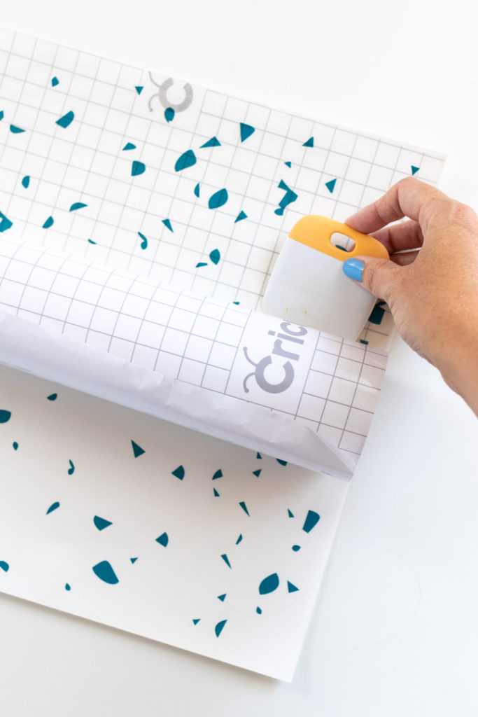 DIY Terrazzo Clock with Vinyl (Free SVG Template!) // Use your Cricut or Silhouette machine to add a colorful terrazzo pattern to a wooden clock with @joann branded adhesive vinyl packs! Simply cut and layer for a unique pieces of wall art using this free cut template! #handmadewithjoann #vinyl #freetemplate #wallart #homedecor #diydecor #terrazzo #cricutmade