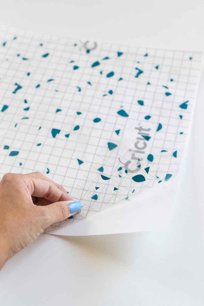 DIY Terrazzo Clock with Vinyl (Free SVG Template!) // Use your Cricut or Silhouette machine to add a colorful terrazzo pattern to a wooden clock with @joann branded adhesive vinyl packs! Simply cut and layer for a unique pieces of wall art using this free cut template! #handmadewithjoann #vinyl #freetemplate #wallart #homedecor #diydecor #terrazzo #cricutmade