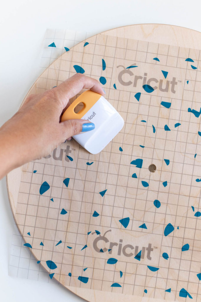 DIY Terrazzo Clock with Vinyl (Free SVG Template!) // Use your Cricut or Silhouette machine to add a colorful terrazzo pattern to a wooden clock with @joann branded adhesive vinyl packs! Simply cut and layer for a unique pieces of wall art using this free cut template! #handmadewithjoann #vinyl #freetemplate #wallart #homedecor #diydecor #terrazzo #cricutmade