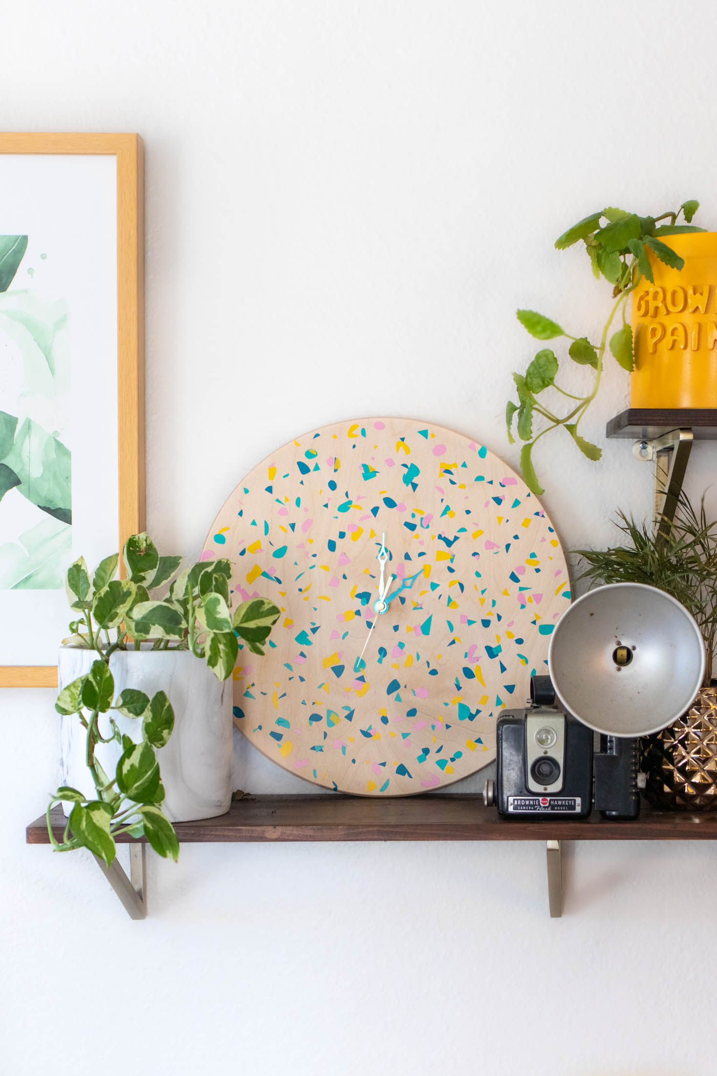 DIY Terrazzo Clock with Vinyl (Free SVG Template!) // Use your Cricut or Silhouette machine to add a colorful terrazzo pattern to a wooden clock with @joann branded adhesive vinyl packs! Simply cut and layer for a unique pieces of wall art using this free cut template! #handmadewithjoann #vinyl #freetemplate #wallart #homedecor #diydecor #terrazzo #cricutmade