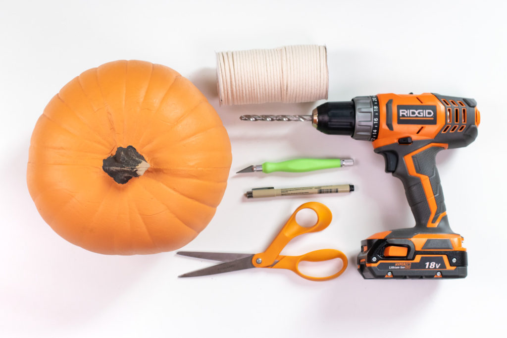 DIY Hanging Pumpkin Planter for Fall // See how to cut a fake pumpkin to make a hanging planter to decorate your home for fall! Fill it with your favorite faux plants or give one as a gift! #pumpkins #homedecor #falldecor #falldiy #halloweendiy #planter #plantlady #fakepumpkins #pumpkincarving