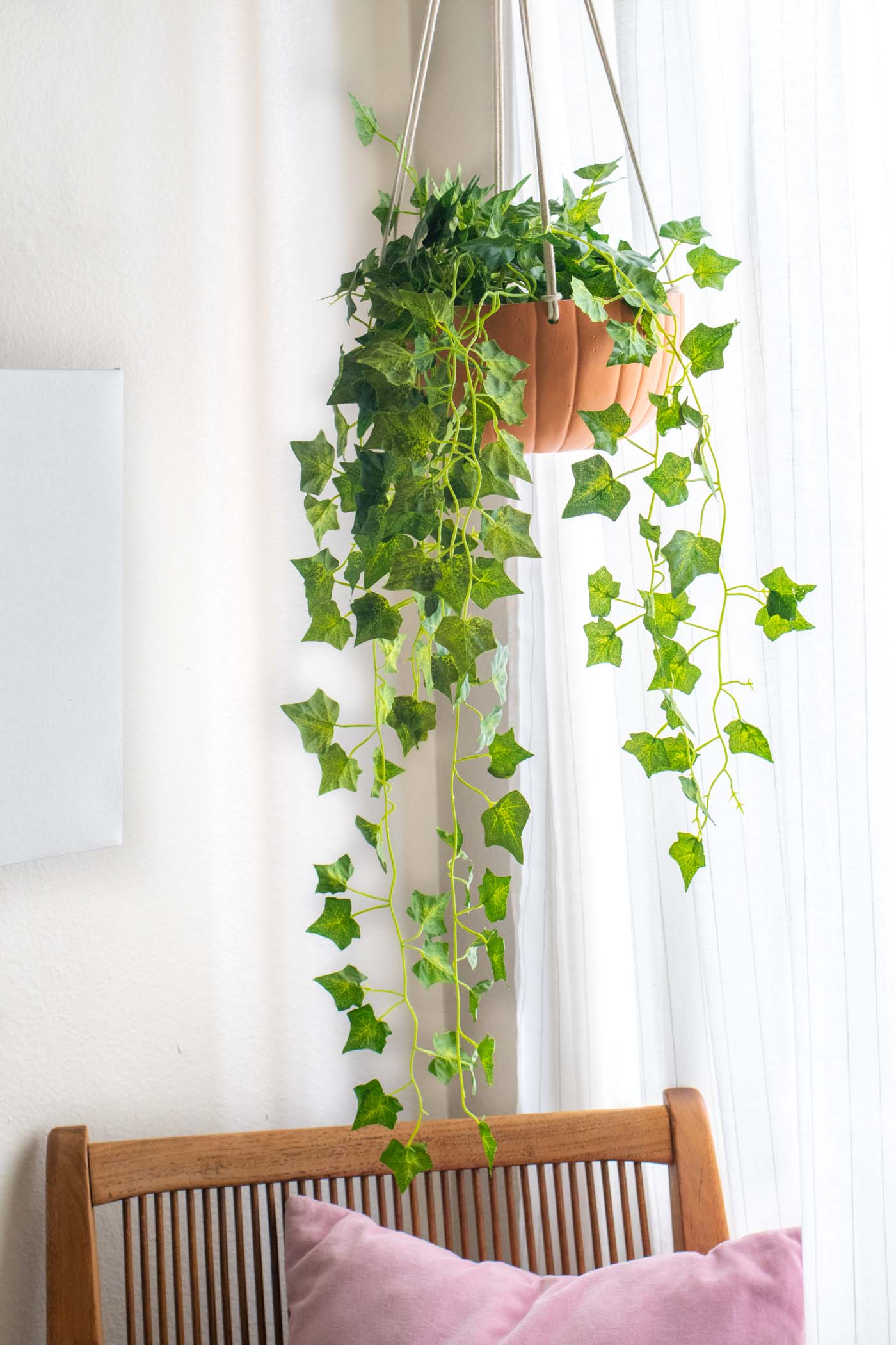 DIY Hanging Pumpkin Planter for Fall // See how to cut a fake pumpkin to make a hanging planter to decorate your home for fall! Fill it with your favorite faux plants or give one as a gift! #pumpkins #homedecor #falldecor #falldiy #halloweendiy #planter #plantlady #fakepumpkins #pumpkincarving