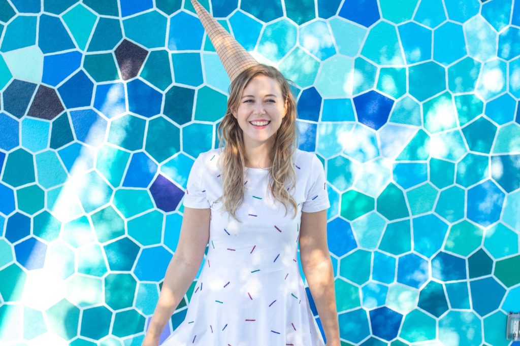 Easy Ice Cream Cone Costume for Halloween // Make a simple food Halloween costume inspired by an ice cream cone with a paper party hat and a glitter painted sprinkle dress! This no-sew Halloween costume is a perfect costume for kids or adults! #nosew #halloween #diycostume #painting #papercrafts #kidscostume #womensfashion #diystyle
