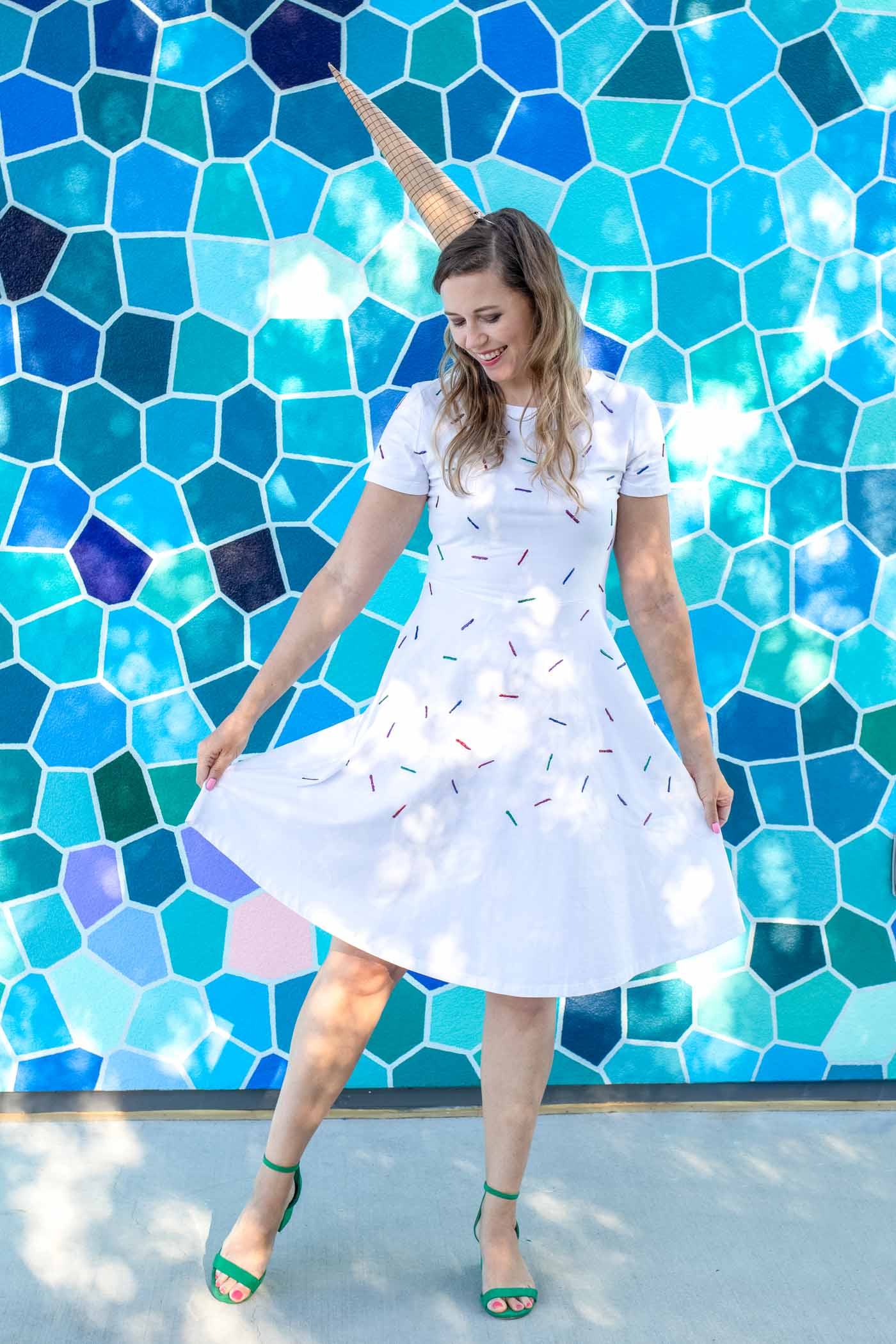 Easy Ice Cream Cone Costume for Halloween // Make a simple food Halloween costume inspired by an ice cream cone with a paper party hat and a glitter painted sprinkle dress! This no-sew Halloween costume is a perfect costume for kids or adults! #nosew #halloween #diycostume #painting #papercrafts #kidscostume #womensfashion #diystyle