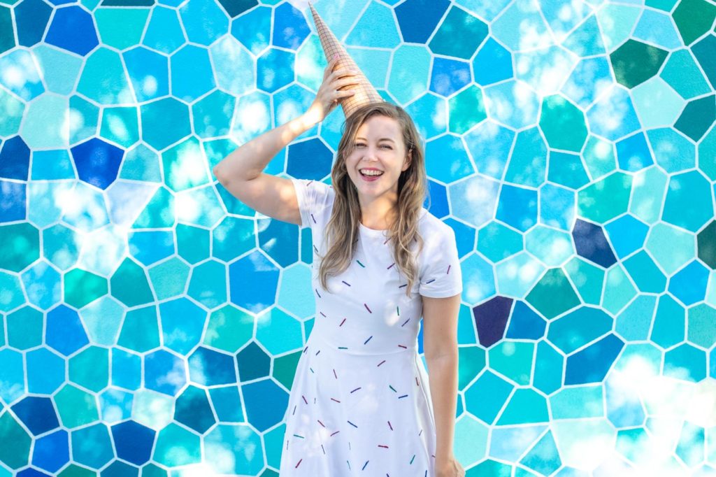 Easy Ice Cream Cone Costume for Halloween // Make a simple food Halloween costume inspired by an ice cream cone with a paper party hat and a glitter painted sprinkle dress! This no-sew Halloween costume is a perfect costume for kids or adults! #nosew #halloween #diycostume #painting #papercrafts #kidscostume #womensfashion #diystyle