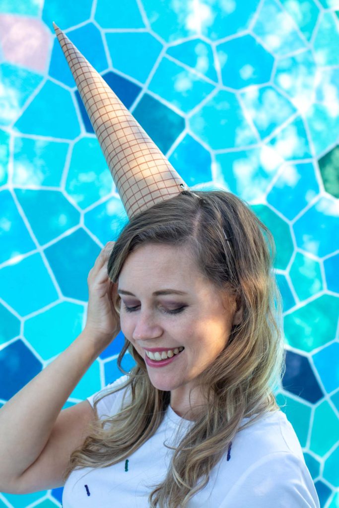 Easy Ice Cream Cone Costume for Halloween // Make a simple food Halloween costume inspired by an ice cream cone with a paper party hat and a glitter painted sprinkle dress! This no-sew Halloween costume is a perfect costume for kids or adults! #nosew #halloween #diycostume #painting #papercrafts #kidscostume #womensfashion #diystyle