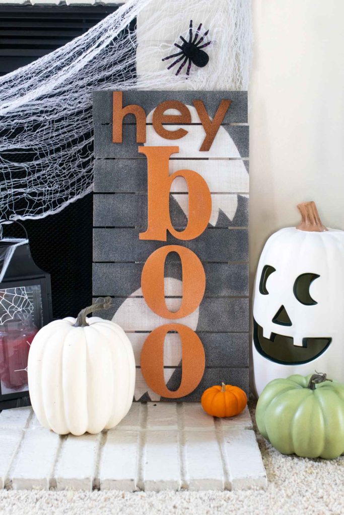 "Hey Boo" Punny Halloween Sign DIY // Make a fun wooden Halloween sign with a punny saying to decorate your home for Halloween! Decorate your front door, fireplace or other corner of your home using supplies from @joann given a makeover with the NEW @rustoleum Imagine collection, including glitter spray paint #ad #handmadewithjoann #halloween #halloweendiy #homedecor #halloweendecor #painting #spraypaint
