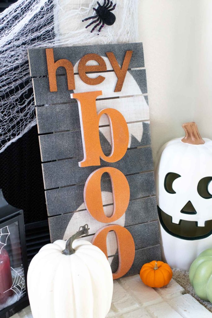 "Hey Boo" Punny Halloween Sign DIY // Make a fun wooden Halloween sign with a punny saying to decorate your home for Halloween! Decorate your front door, fireplace or other corner of your home using supplies from @joann given a makeover with the NEW @rustoleum Imagine collection, including glitter spray paint #ad #handmadewithjoann #halloween #halloweendiy #homedecor #halloweendecor #painting #spraypaint