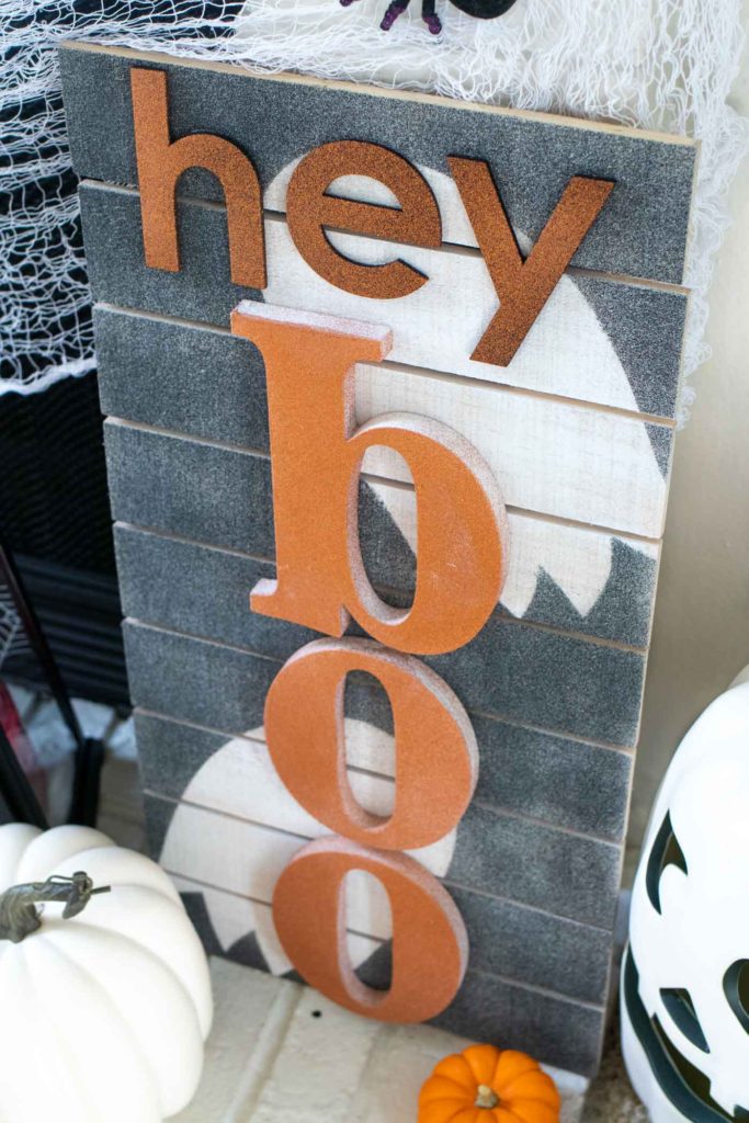 "Hey Boo" Punny Halloween Sign DIY // Make a fun wooden Halloween sign with a punny saying to decorate your home for Halloween! Decorate your front door, fireplace or other corner of your home using supplies from @joann given a makeover with the NEW @rustoleum Imagine collection, including glitter spray paint #ad #handmadewithjoann #halloween #halloweendiy #homedecor #halloweendecor #painting #spraypaint