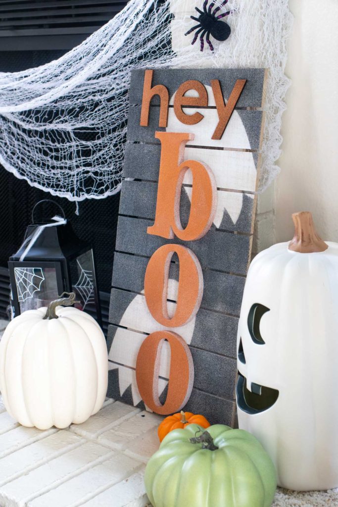 "Hey Boo" Punny Halloween Sign DIY // Make a fun wooden Halloween sign with a punny saying to decorate your home for Halloween! Decorate your front door, fireplace or other corner of your home using supplies from @joann given a makeover with the NEW @rustoleum Imagine collection, including glitter spray paint #ad #handmadewithjoann #halloween #halloweendiy #homedecor #halloweendecor #painting #spraypaint