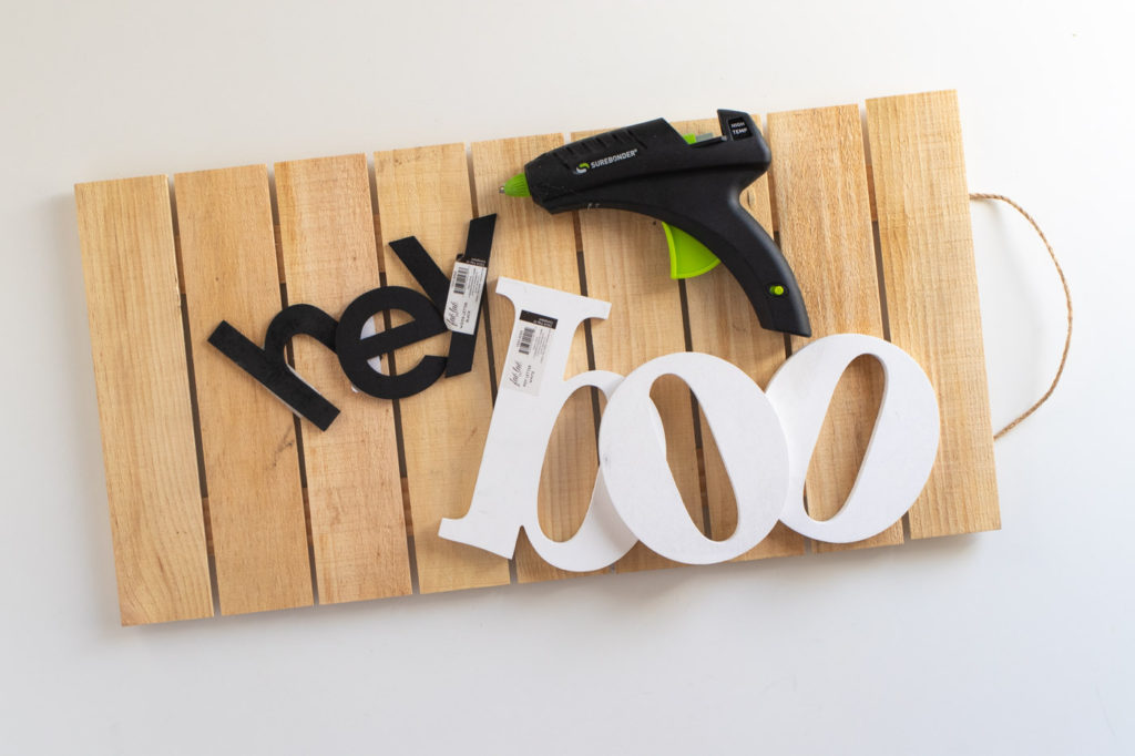 "Hey Boo" Punny Halloween Sign DIY // Make a fun wooden Halloween sign with a punny saying to decorate your home for Halloween! Decorate your front door, fireplace or other corner of your home using supplies from @joann given a makeover with the NEW @rustoleum Imagine collection, including glitter spray paint #ad #handmadewithjoann #halloween #halloweendiy #homedecor #halloweendecor #painting #spraypaint