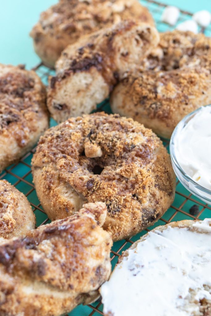 Homemade S'mores Bagels // Make a batch of sweet, buttery smores bagels with a yeast bagel base, chocolate chunks and a gooey marshmallow graham cracker topping! These are the perfect sweet breakfast treat for kids and adults! #bagels #yeastdough #breadrecipes #recipes #breakfast #smores #breakfastrecipes #brunchrecipes