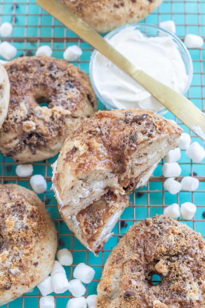 Homemade S'mores Bagels // Make a batch of sweet, buttery smores bagels with a yeast bagel base, chocolate chunks and a gooey marshmallow graham cracker topping! These are the perfect sweet breakfast treat for kids and adults! #bagels #yeastdough #breadrecipes #recipes #breakfast #smores #breakfastrecipes #brunchrecipes