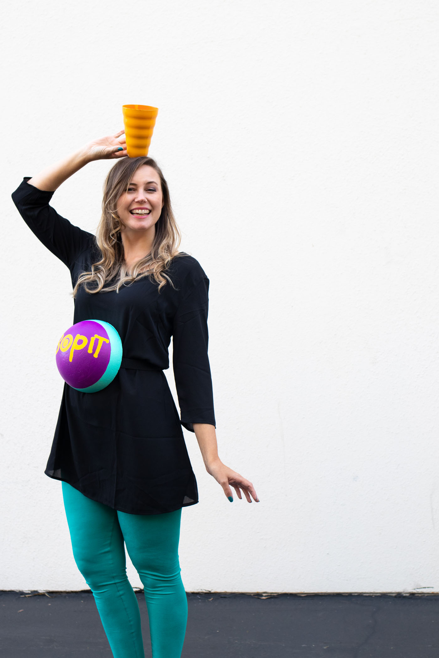 DIY Bop It! Costume // Recreate the classic 90s toy Bop It! with a few simple supplies! This easy 90s toy costume is the perfect nostalgic costume for adults! #costume #halloween #90s #toycostume #adultcostume #halloweencostume #diycostume