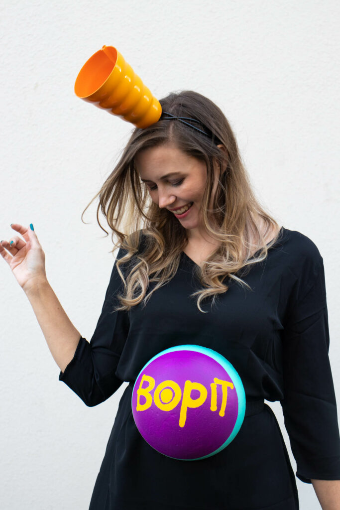 DIY Bop It! Costume // Recreate the classic 90s toy Bop It! with a few simple supplies! This easy 90s toy costume is the perfect nostalgic costume for adults! #costume #halloween #90s #toycostume #adultcostume #halloweencostume #diycostume