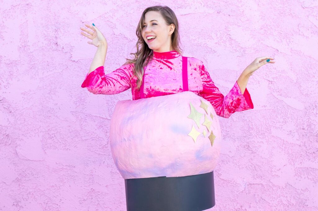 DIY Crystal Ball Costume for Halloween // Use paper mache on a large balloon to create a DIY halloween costume that looks like a mystical crystal ball used by a fortune teller! #crystalball #papermache #halloween #costume #kidscostume #adultcostume