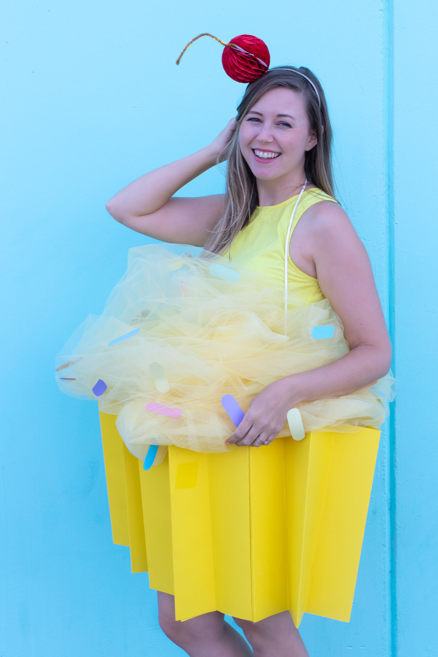 DIY Cupcake Costume for Halloween // Make yourself into a cupcake for Halloween with this fun DIY costume for kids or adults using poster board and tulle! #diycostume #halloween #kidscostumes #adultcostumes #cupcake #halloweendiy #halloweencostume