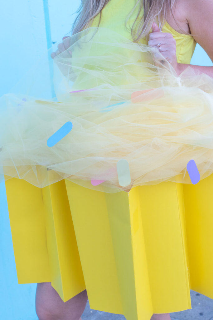DIY Cupcake Costume for Halloween // Make yourself into a cupcake for Halloween with this fun DIY costume for kids or adults using poster board and tulle! #diycostume #halloween #kidscostumes #adultcostumes #cupcake #halloweendiy #halloweencostume