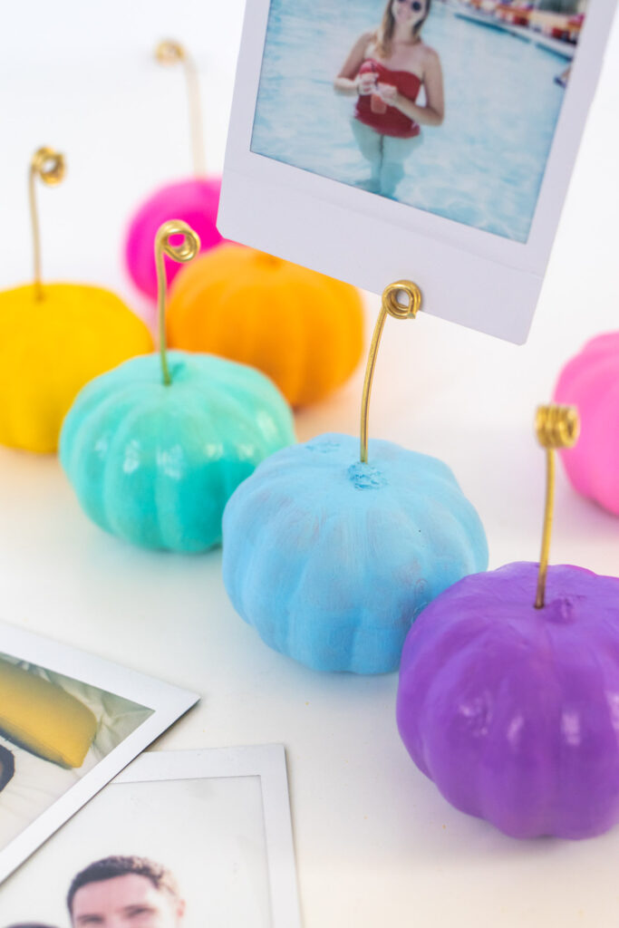 DIY Wire Pumpkin Photo Holders (Place Cards)| Paint mini pumpkins and add wire to create DIY place cards or mini photo holders to decorate for fall and Thanksgiving! #pumpkin #falldiy #falldecor #painting #photoholder #thanksgiving #tablescape #placesetting