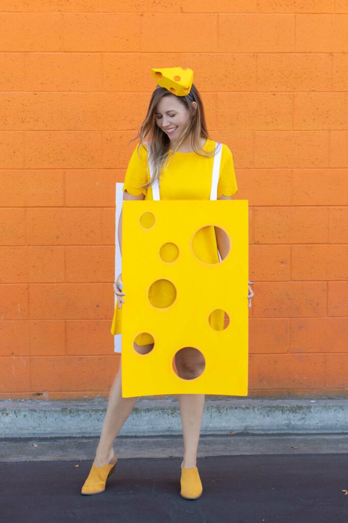 DIY Easy Cheese Costume (Cheeseboard Costume) // Use poster board to make a fun cheesy costume complete with a wedge of cheese headband! This easy last-minute costume is perfect for kids or adults to wear this Halloween #costume #easycostume #diycostume #halloween #adultcostumes #kidscostumes #cheese #posterboard