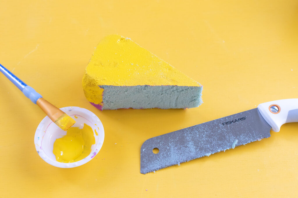 DIY Easy Cheese Costume (Cheeseboard Costume) // Use poster board to make a fun cheesy costume complete with a wedge of cheese headband! This easy last-minute costume is perfect for kids or adults to wear this Halloween #costume #easycostume #diycostume #halloween #adultcostumes #kidscostumes #cheese #posterboard
