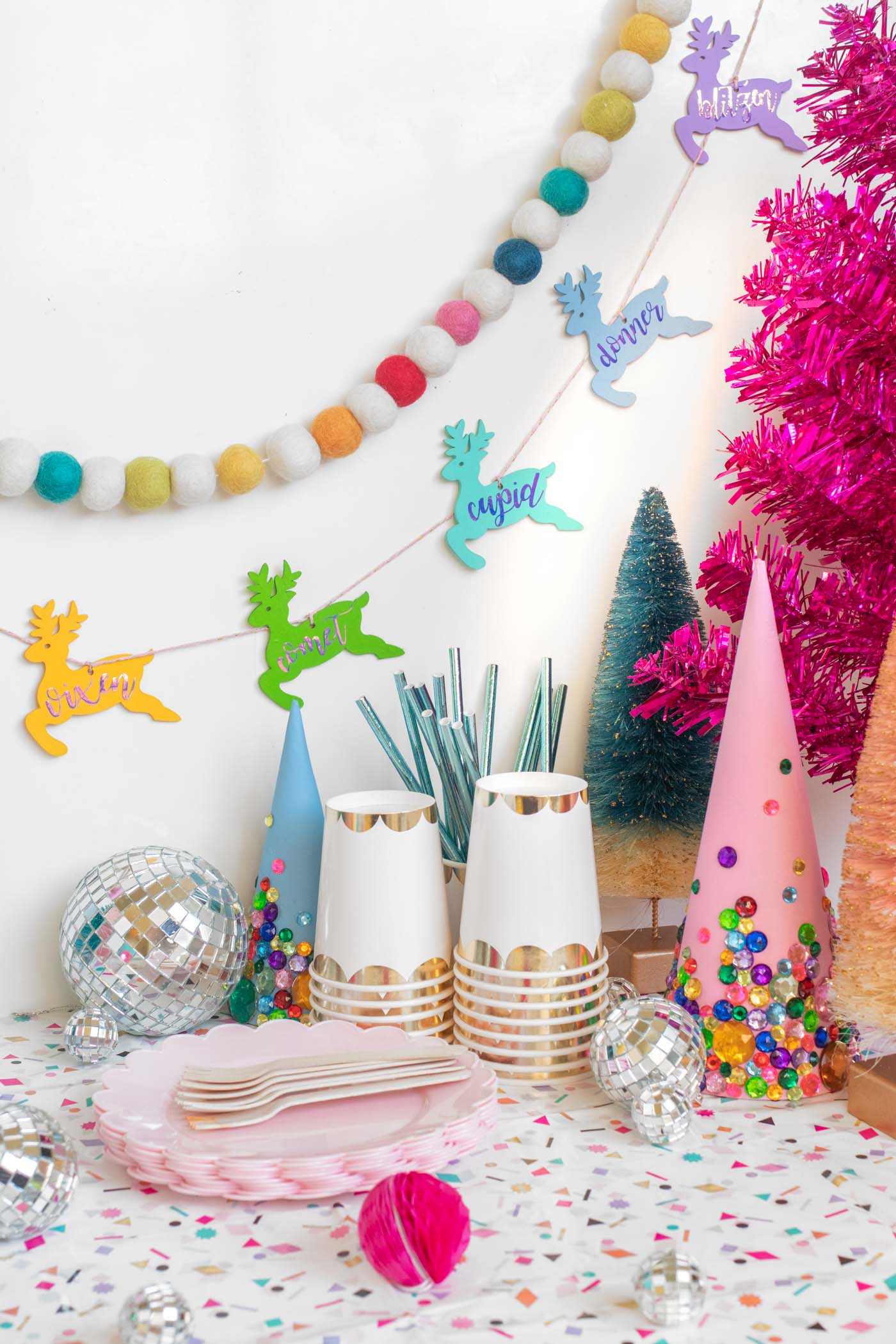 DIY Rainbow Reindeer Garland for Christmas // Paint wooden reindeer ornaments and add holographic vinyl to make a colorful Christmas garland with the names of Santa's reindeer! #christmasdecor #christmas #christmasdiy #rainbowdiy #reindeer #vinyl #cricut #painting