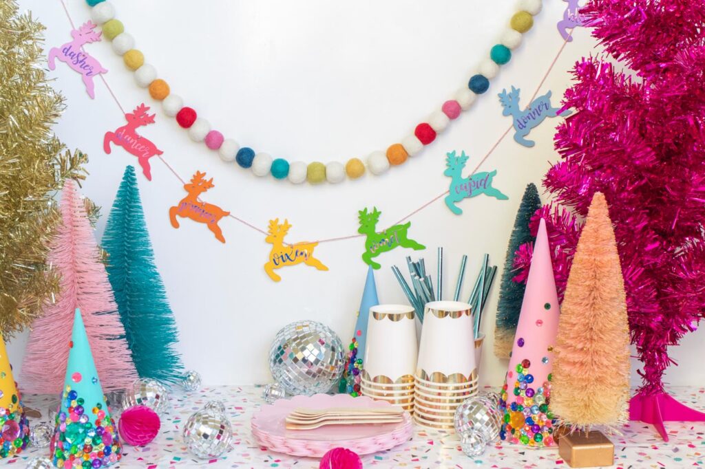DIY Rainbow Reindeer Garland for Christmas // Paint wooden reindeer ornaments and add holographic vinyl to make a colorful Christmas garland with the names of Santa's reindeer! #christmasdecor #christmas #christmasdiy #rainbowdiy #reindeer #vinyl #cricut #painting