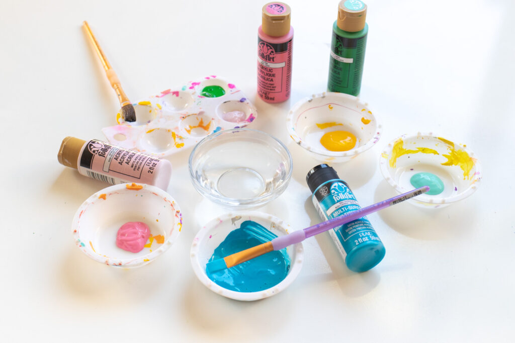 DY Splatter Painted Gift Wrap // Make your own wrapping paper with this simple splatter technique using colorful supplies from @joann! Add 80s and 90s-inspired splatter designs to plain paper for fun DIY gift wrap for Christmas and beyond! #ad #handmadewithjoann #giftwrap #diygiftwrap #wrappingpaper #splatterpaint #painting #rainbow