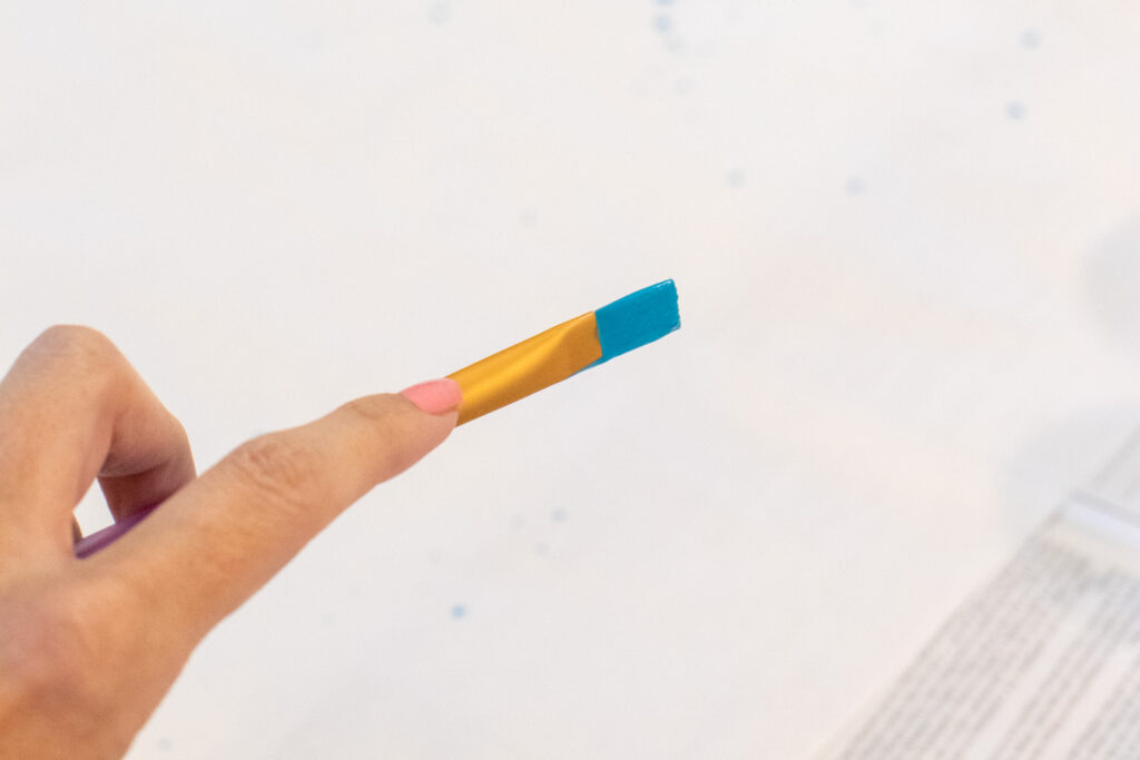 DY Splatter Painted Gift Wrap // Make your own wrapping paper with this simple splatter technique using colorful supplies from @joann! Add 80s and 90s-inspired splatter designs to plain paper for fun DIY gift wrap for Christmas and beyond! #ad #handmadewithjoann #giftwrap #diygiftwrap #wrappingpaper #splatterpaint #painting #rainbow