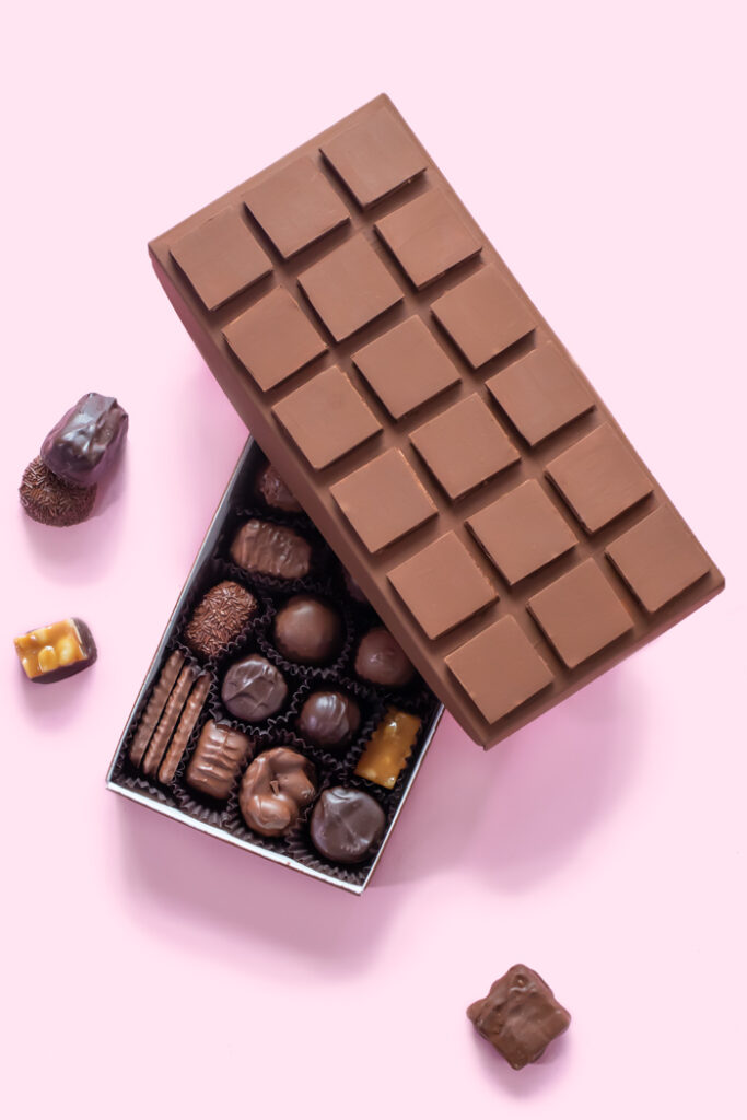 DIY Chocolate Box Makeover for Valentine's Day // Turn a plain box of chocolate into a giant chocolate bar with poster board and paint! This oversized chocolate box makes a fun just-because gift or a DIY valentine! #valentinesday #vday #diyvalentine #paint #posterboard #papercrafts #giftideas