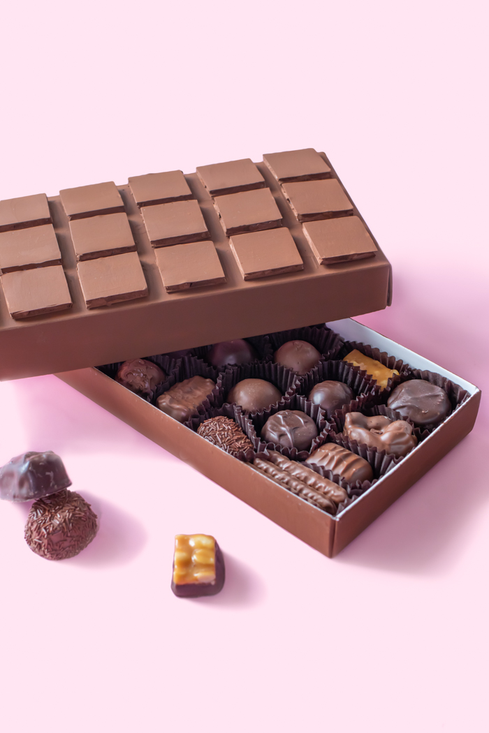 DIY Chocolate Box Makeover for Valentine's Day // Turn a plain box of chocolate into a giant chocolate bar with poster board and paint! This oversized chocolate box makes a fun just-because gift or a DIY valentine! #valentinesday #vday #diyvalentine #paint #posterboard #papercrafts #giftideas