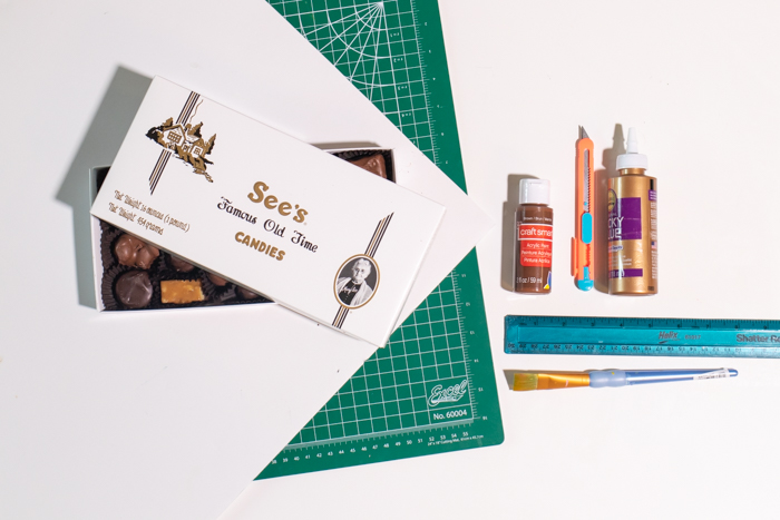 DIY Chocolate Box Makeover for Valentine's Day // Turn a plain box of chocolate into a giant chocolate bar with poster board and paint! This oversized chocolate box makes a fun just-because gift or a DIY valentine! #valentinesday #vday #diyvalentine #paint #posterboard #papercrafts #giftideas