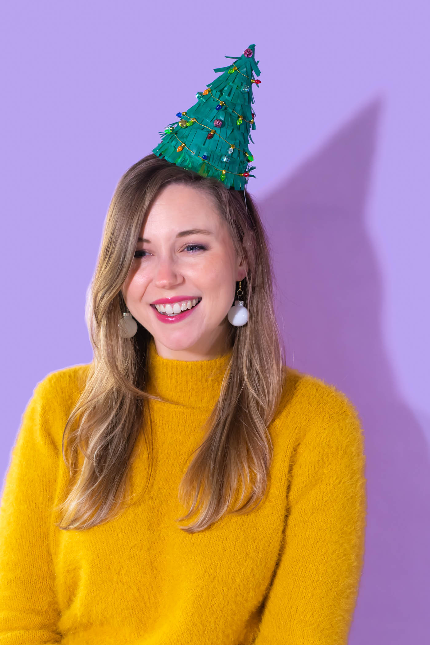 DIY Christmas Tree Party Hats // Turn a plain party hat into a fun holiday craft with tissue paper! Upcycle your hats into fringed Christmas trees decorated with lights and ornaments! #christmas #christmasdiy #christmascrafts #partydiy #partyideas #holidayparty #christmasparty #partyhats