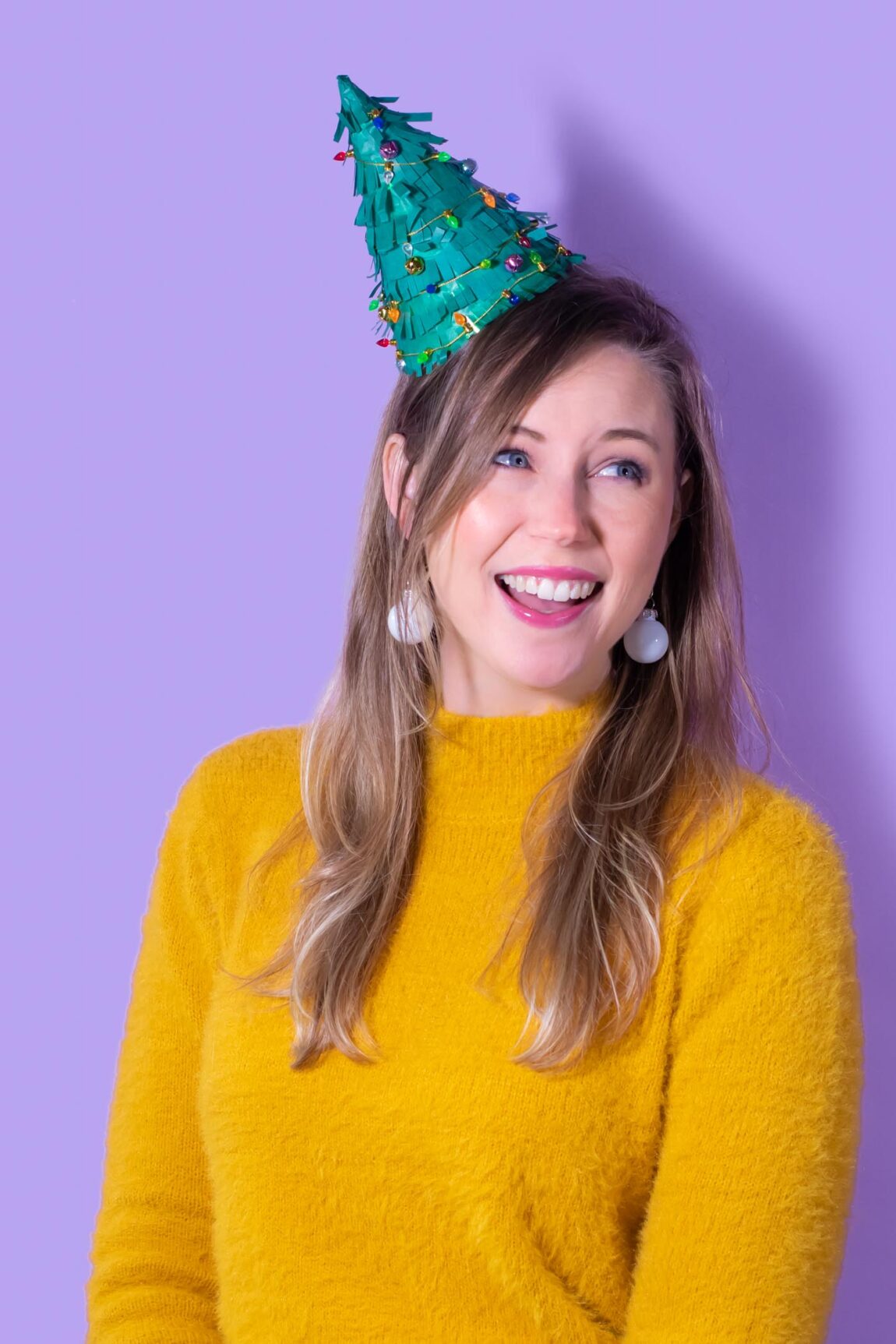 DIY Christmas Tree Party Hats // Turn a plain party hat into a fun holiday craft with tissue paper! Upcycle your hats into fringed Christmas trees decorated with lights and ornaments! #christmas #christmasdiy #christmascrafts #partydiy #partyideas #holidayparty #christmasparty #partyhats