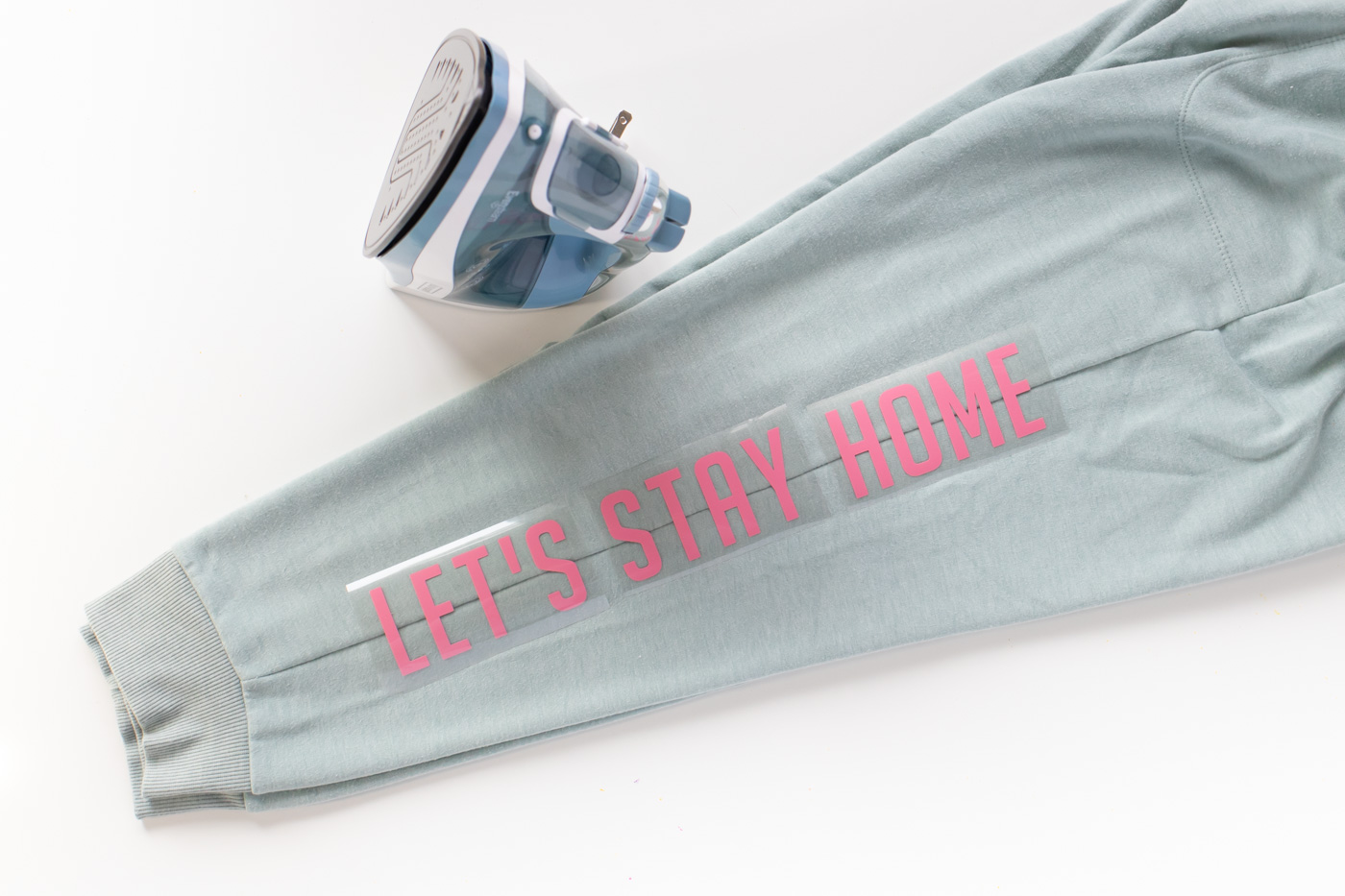 "Let's Stay Home" DIY Graphic Sweatpants with Iron-On Vinyl (Cricut) // Update a pair of plain sweats with a cute saying using vinyl! #cricutmade #ironon #vinyl #fashion #diyfashion #nosew #sweatpants #womensstyle #stylediy