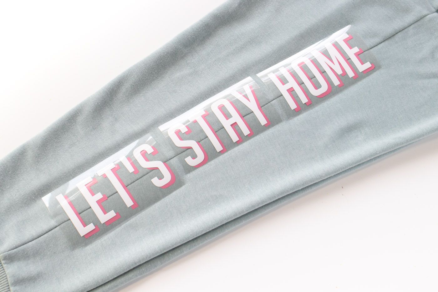 "Let's Stay Home" DIY Graphic Sweatpants with Iron-On Vinyl (Cricut) // Update a pair of plain sweats with a cute saying using vinyl! #cricutmade #ironon #vinyl #fashion #diyfashion #nosew #sweatpants #womensstyle #stylediy