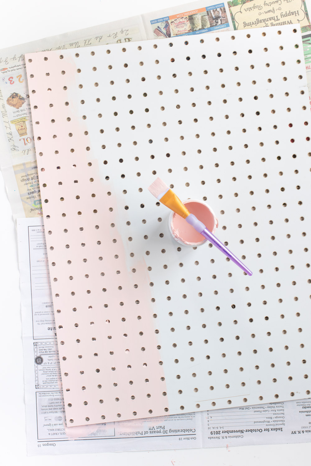 DIY Holiday Pegboard Card Holder // Turn a slab of pegboard into a fun Christmas tree card display inspired by string art! Display your holiday cards in a unique way with this DIY Christmas decor idea #christmasdiy #christmascard #christmasdecor #christmasstorage #pegboard #papercrafts #stringart #holidaystorage #cardstorage