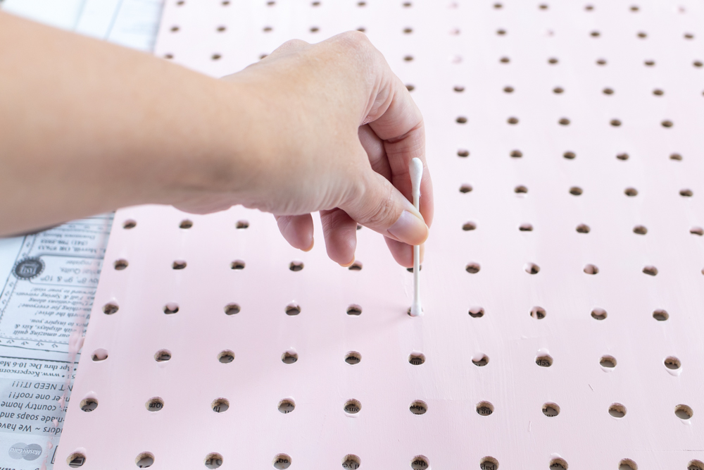 DIY Holiday Pegboard Card Holder // Turn a slab of pegboard into a fun Christmas tree card display inspired by string art! Display your holiday cards in a unique way with this DIY Christmas decor idea #christmasdiy #christmascard #christmasdecor #christmasstorage #pegboard #papercrafts #stringart #holidaystorage #cardstorage