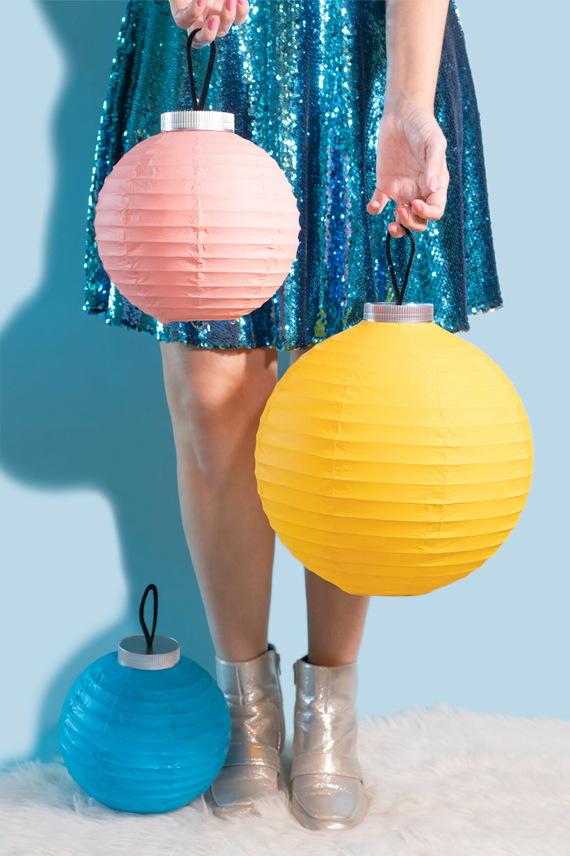 DIY Ornament Lanterns // Turn plain white lanterns into colorful ornament decor with this easy Christmas DIY! Paint lanterns and add tops to make them look like oversized ornaments for your holiday decor! #christmas #christmasdiy #painting #lanterns #papercrafts #homedecor #easydiy #upcycling