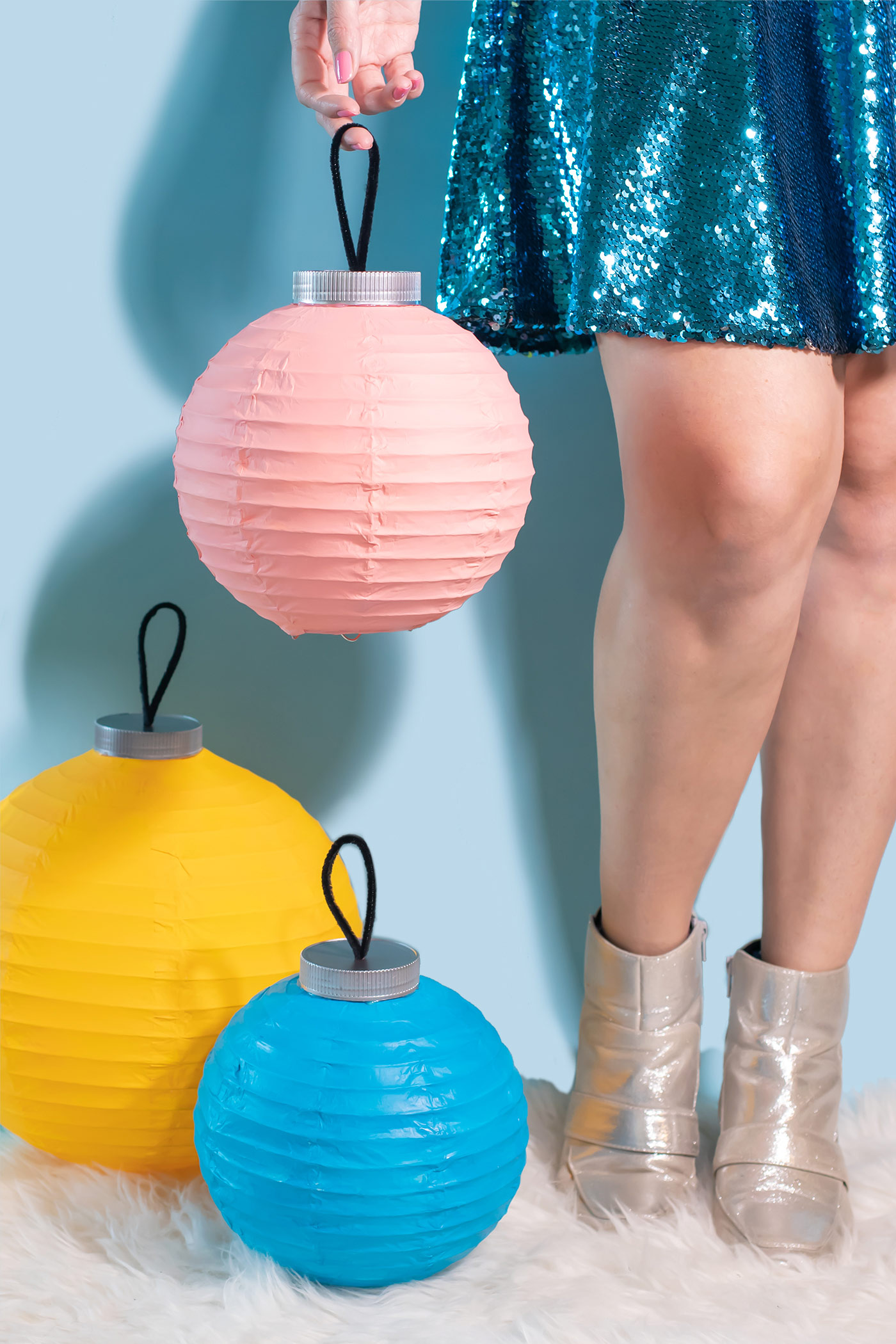 DIY Ornament Lanterns // Turn plain white lanterns into colorful ornament decor with this easy Christmas DIY! Paint lanterns and add tops to make them look like oversized ornaments for your holiday decor! #christmas #christmasdiy #painting #lanterns #papercrafts #homedecor #easydiy #upcycling