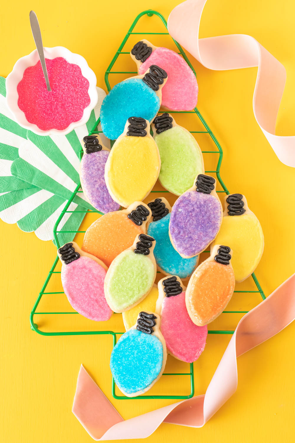 Easy Christmas Light Cookies with Sprinkles // Decorate sugar cookies to look like Christmas lights in different colors! Use sugar crystal sprinkles and black icing to create colorful light cookies for celebrating Christmas! #christmas #christmascookies #sugarcookies #sprinkles #cookierecipes #cookiedecorating #christmasdesserts #cookieswap