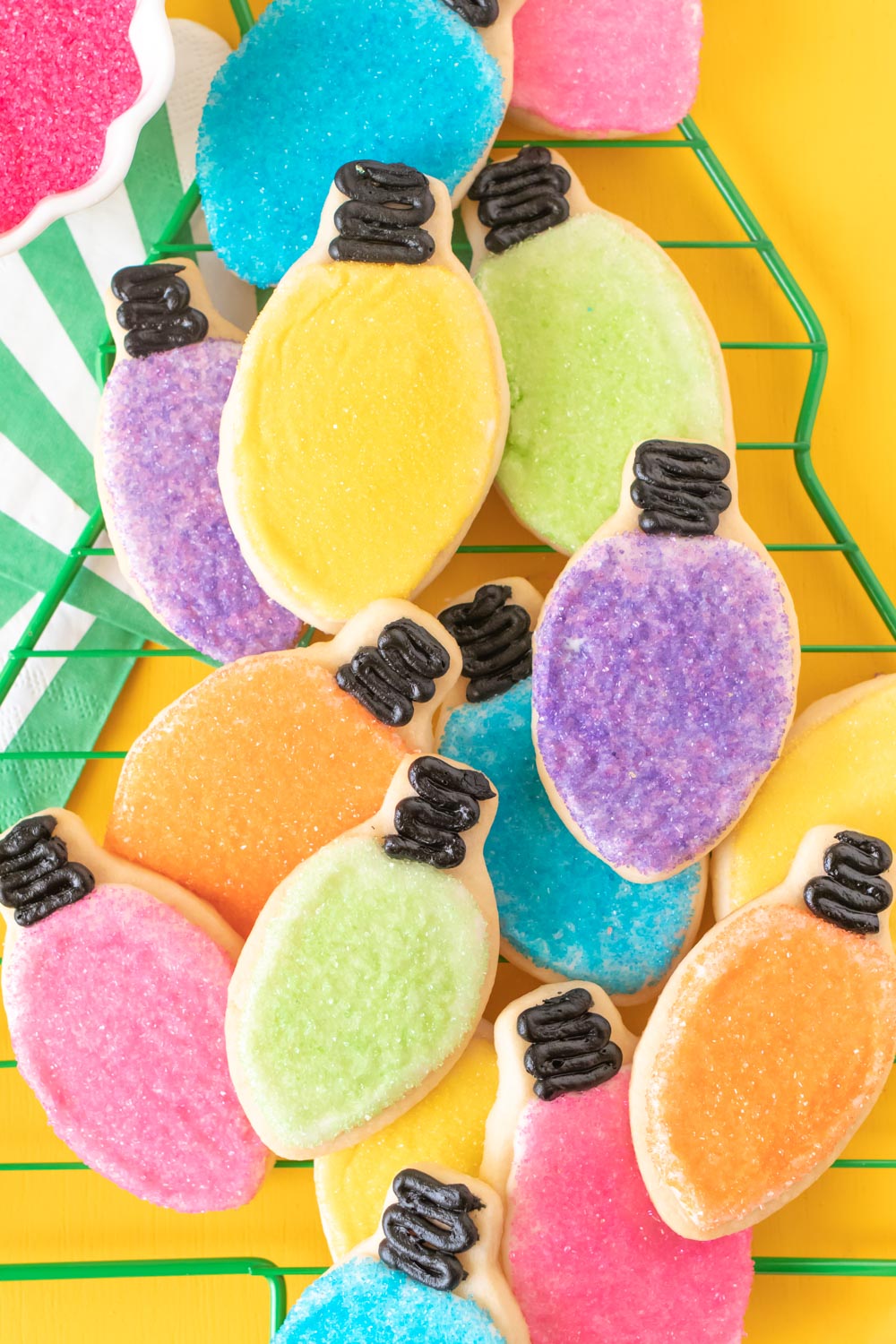 Easy Christmas Light Cookies with Sprinkles // Decorate sugar cookies to look like Christmas lights in different colors! Use sugar crystal sprinkles and black icing to create colorful light cookies for celebrating Christmas! #christmas #christmascookies #sugarcookies #sprinkles #cookierecipes #cookiedecorating #christmasdesserts #cookieswap